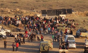Syrians wait at the border areas near Jordan after they fled from the ongoing military operations