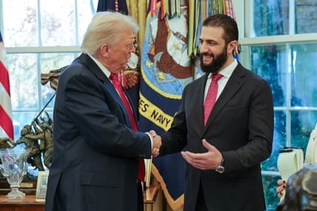 Trump shaking hands with Sharaa at the White House in November.