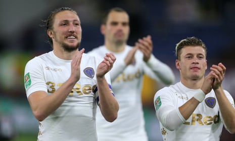 Luke Ayling (left) and Ezgjan Alioski applaud supporters after Leeds defeated Burnley on penalties at Turf Moor.
