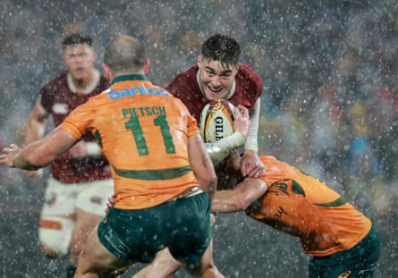 Tommy Freeman is tackled in the rain while playing for the Lions against Australia