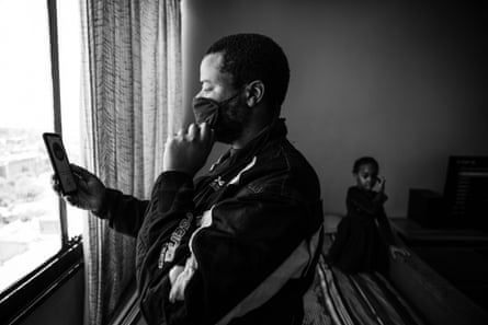 Lovemore updates his identity photograph on his app before leaving for work