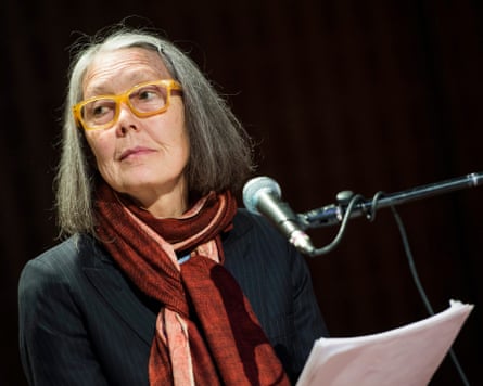Anne Carson speaking at a microphone