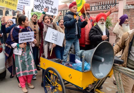 Students along with their parents hold placards and shout slogans in support of farmers protesting against the central government’s recent agricultural reforms, in Amritsar, Punjab.