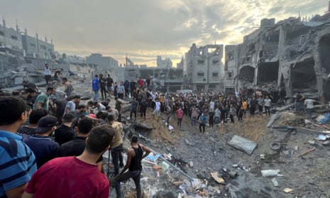 Palestinians search for casualties at the site of Israeli strikes on Jabalia refugee camp in northern Gaza.