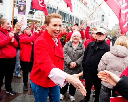 Mette Frederiksen holds out her hand for a handshake