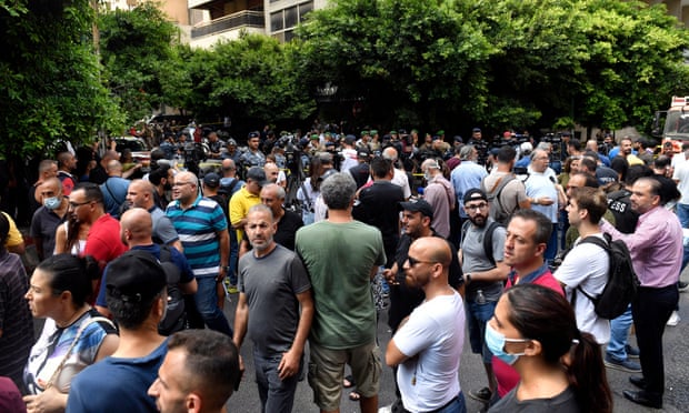 Crowds gather in the street outside the Federal Bank in Beirut’s Hamra district