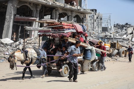 Palestinians flee with their possessions on a cart pulled by a mule
