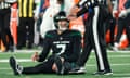 New York Jets quarterback Tim Boyle is helped to his feet by an official after a play in the second half of Friday’s loss to the Miami Dolphins at MetLife Stadium.