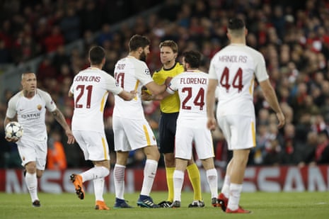 The Roma players remonstrate as referee Felix Brych shows a yellow card to Federico Fazio.