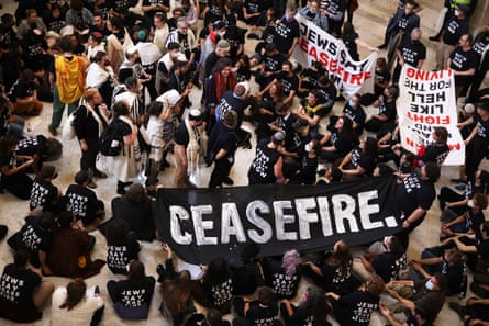 people hold a banner that reads ‘ceasefire’