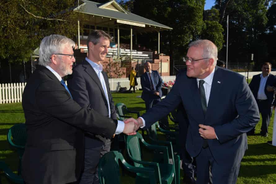 Prime minister Scott Morrison shakes hands with former prime minister, Kevin Rudd, before the Eid prayer service in Parramatta Park.