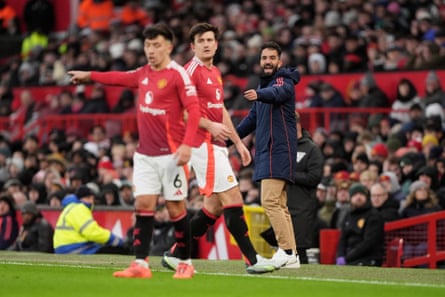 Harry Maguire in action for Manchester United, with Ruben Amorim shouting instructions in the background