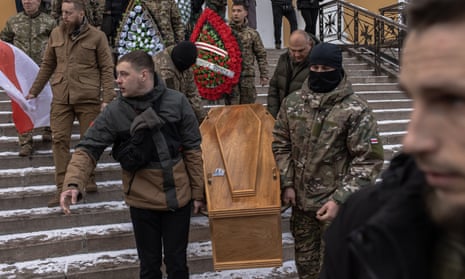 Mourners carry the coffin of Eduard Lobov, who was killed in the Donetsk region, after a memorial service at the Cathedral of St Alexander, in Kyiv, Ukraine. Lobov, originally from Belarus, had been reportedly fighting with Ukrainian forces since 2015