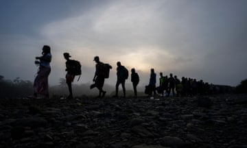 PANAMA-COLOMBIA-US-MIGRATION<br>Migrants walk by the jungle near Bajo Chiquito village, the first border control of the Darien Province in Panama, on September 22, 2023. The clandestine journey through the Darien Gap usually lasts five or six days, at the mercy of all kinds of bad weather. More than 390,000 migrants have entered Panama through this jungle so far this year, far more than in all of 2022, when there were 248,000, according to official Panamanian data. (Photo by Luis ACOSTA / AFP) (Photo by LUIS ACOSTA/AFP via Getty Images) FTAMIGRANTS