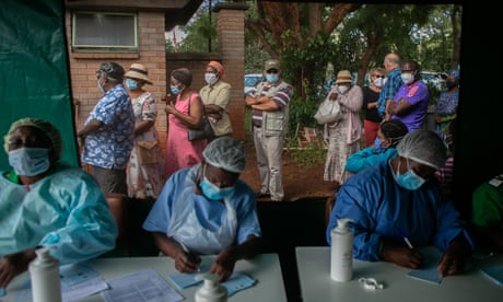 Elderly people queue for the Sinopharm vaccination outside the tent while nurses prepare paperwork at a local hospital on 29 March in Harare, Zimbabwe.