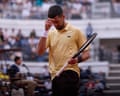 Novak Djokovic puts his hand on his head