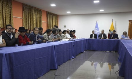 Indigenous leaders (eft) attend negotiations with President Lenín Moreno (third from right) in Quito
