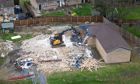 Digger demolishing the outbuilding