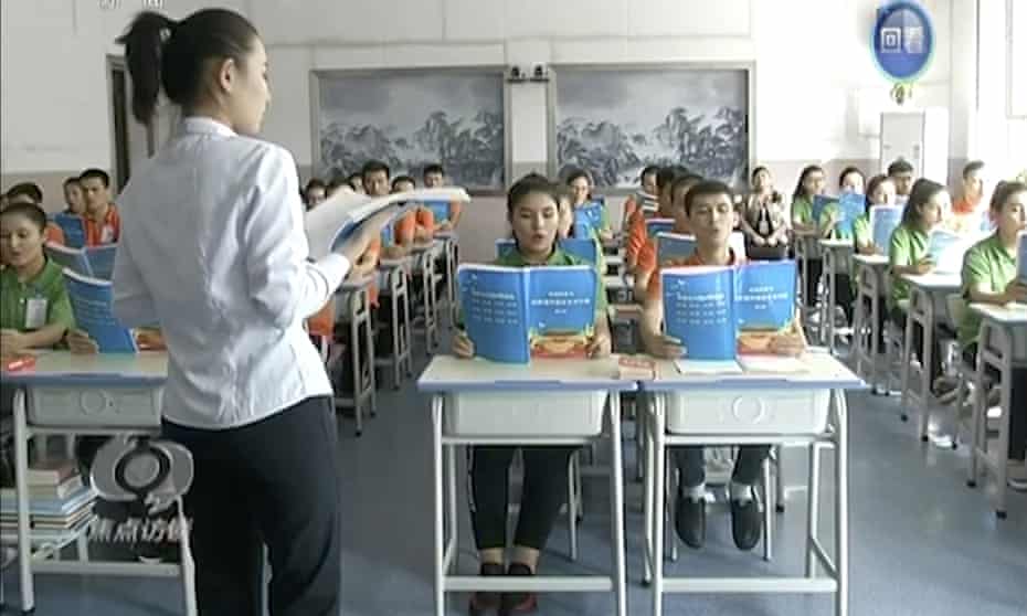 In this image from China’s CCTV, young Muslims read from official Chinese language textbooks in classrooms at the ‘Hotan Vocational Education and Training Center’ in Xinjiang