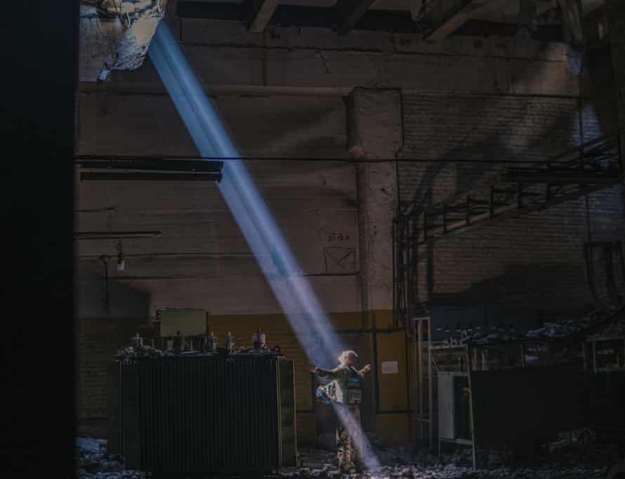 A Ukrainian soldier inside Mariupol's Azovstal steel plant stands in a ray of sunlight on 7 May.