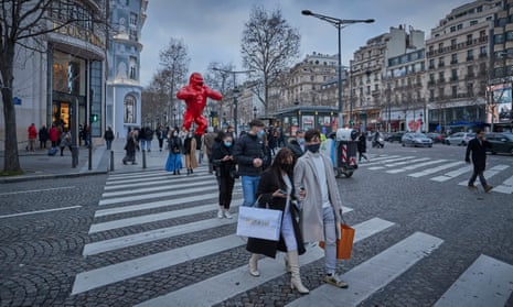 Shoppers walk down the Champs-Élysées in Paris. Hans Kluge, the WHO’s Europe director, said there will be a ‘ceasefire’ in the pandemic.