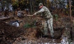 A Ukrainian soldier digs a trench in the northern Kherson area on Sunday.