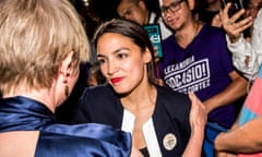 Woman with red lipstick and navy and white jacket looks at at a person.