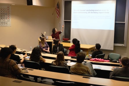 A woman leads a discussion with a classroom full of students