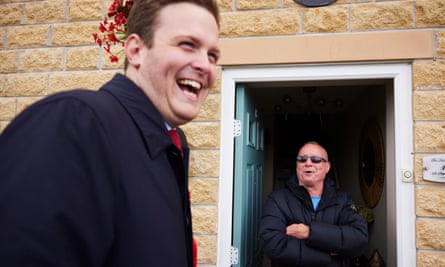 Oliver Ryan laughing while talking to William Harbour who is standing in the doorway of his house smiling with arms folded