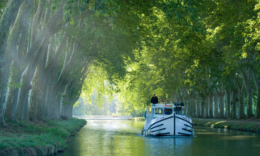 France, Languedoc, Carcassonne:  boat in tree lined canal