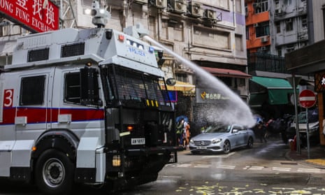 A deployed water cannon targets protesters in Hong Kong.