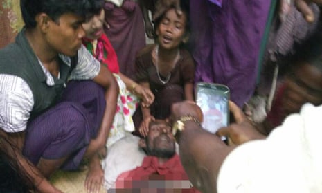 A Rohingya reporter photographs a man allegedly shot by security forces in Rakhine.