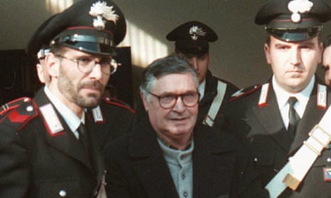 Salvatore ‘Toto’ Riina is led handcuffed into Bologna’s bunker-courtroom