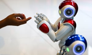 A man plays with a “Nao” humanoid robot