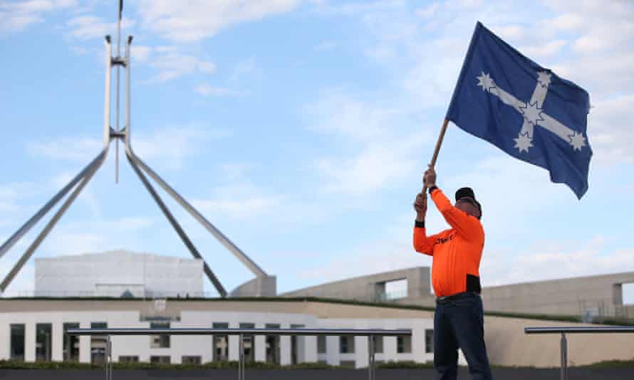 CFMEU Canberra member Dusty Miller who once poured concrete when Parliament House was being built waves the Eureka flag on the front lawns of Parliament House, Canberra, 7 February 2018.