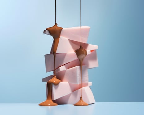 A stack of pink blocks with runny brown makeup dripping down them.
