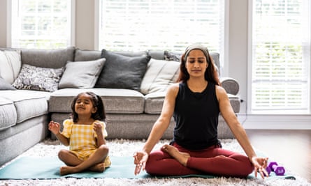 Mother and toddler daughter meditating at home