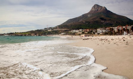 View along surf and beach to mountain at Camps Bay, Cape Town,