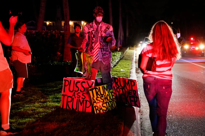 A protester demonstrates outside the home of former President Donald Trump.