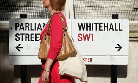 Woman walks past sign for Whitehall