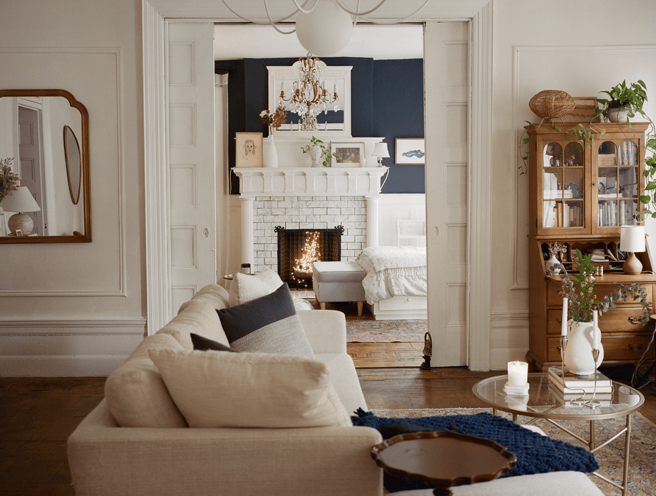 Bedroom seen through pocket doors and a living room