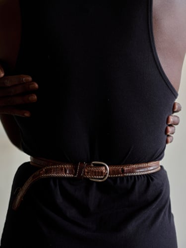 Self-portrait in black tank top and brown leather belt, Black Belt, 2025The belt pulls the body tightlyinwards, while the handsanswer with an embrace.Within the memory of domesticviolence, the gesture becomesless an act of solitary repairthan a way of recalling andcarrying forward forms of carelearned through others.