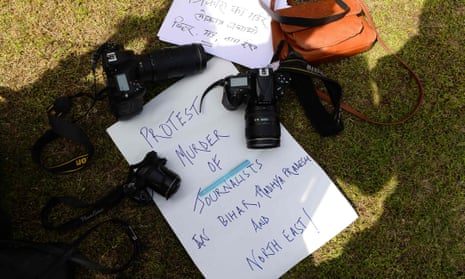 A placard surrounded by cameras during a protest in New Delhi over the killing of Sandeep Sharma.