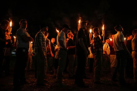 people carry torches in the dark