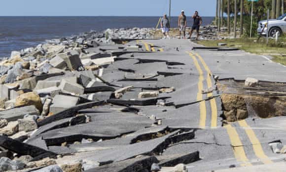 A collapsed road after a hurricane storm surge in Florida