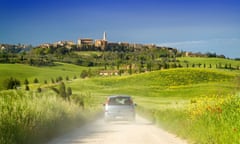 A car driving through the Tuscan landscape