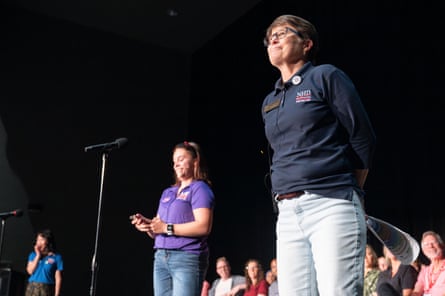 Women stand on stage