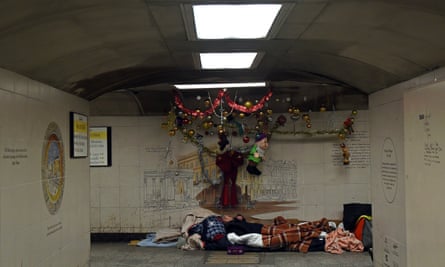 A homeless man with Christmas decorations.
