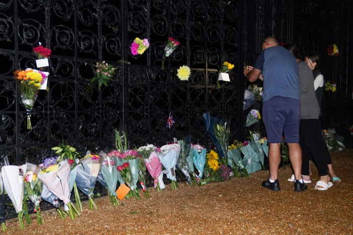 People lay flowers and pay their respects at the gate of Sandringham House in Norfolk.