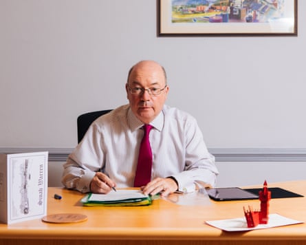 Alistair Burt sitting at a desk.